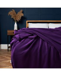 Microfleece Throw, Plum on bed agaisnt blue wooden panel wall